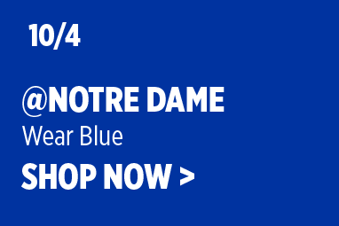 Boise State Football promotional graphic on a royal-blue background. White text reads: '10/4 @ Notre Dame' with subtext 'Wear Blue' and 'SHOP NOW >'.