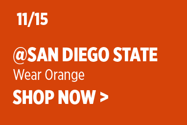 Boise State Football graphic on a solid orange background. White text reads: '11/15 @ San Diego State' with subtext 'Wear Orange' and 'SHOP NOW >'.
