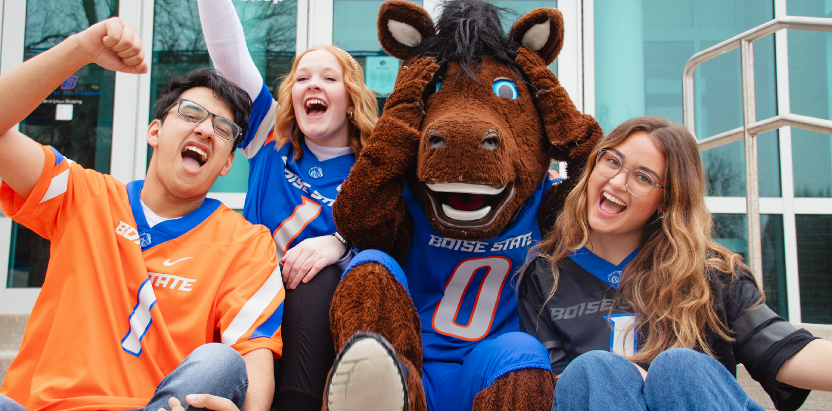 Large image showing Buster Bronco and 3 students in jerseys!