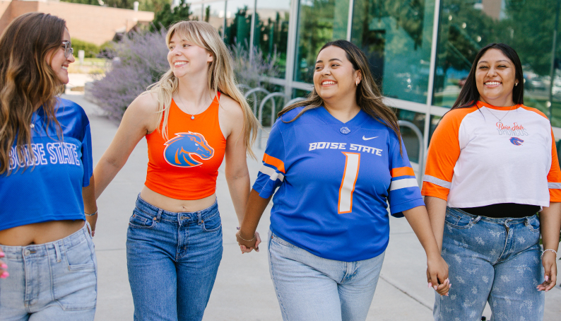 Slideshow image showing Buster Bronco and 3 students in jerseys showing Gear Up for Stripe the Field Orange and Blue for the home game this friday!