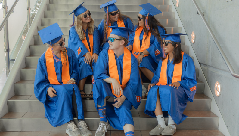 Slideshow image showing a 6 students in Graduation Regalia!