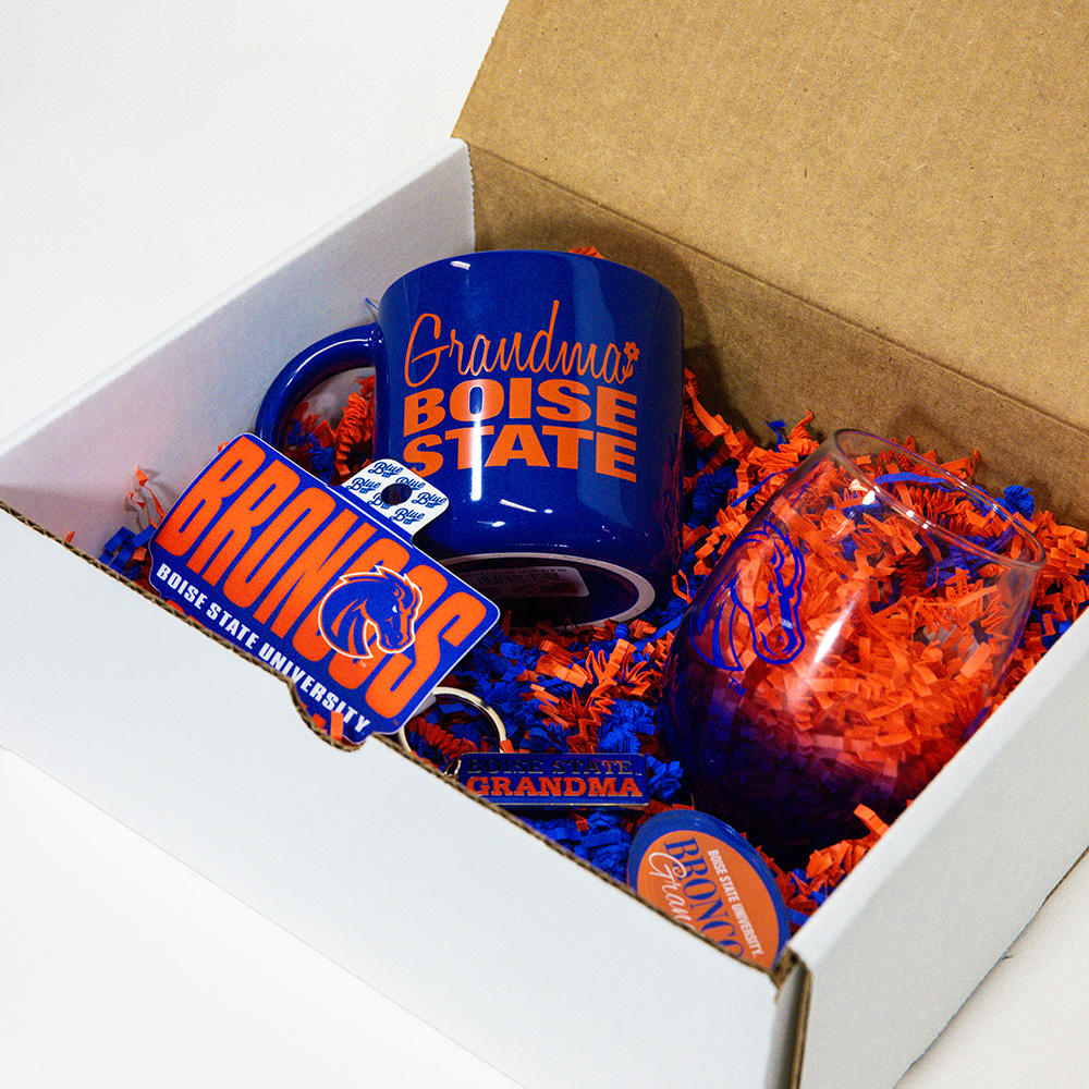 Open Boise State Grandma gift box showing the mug, stemless glass, decals, magnet, and keychain inside.