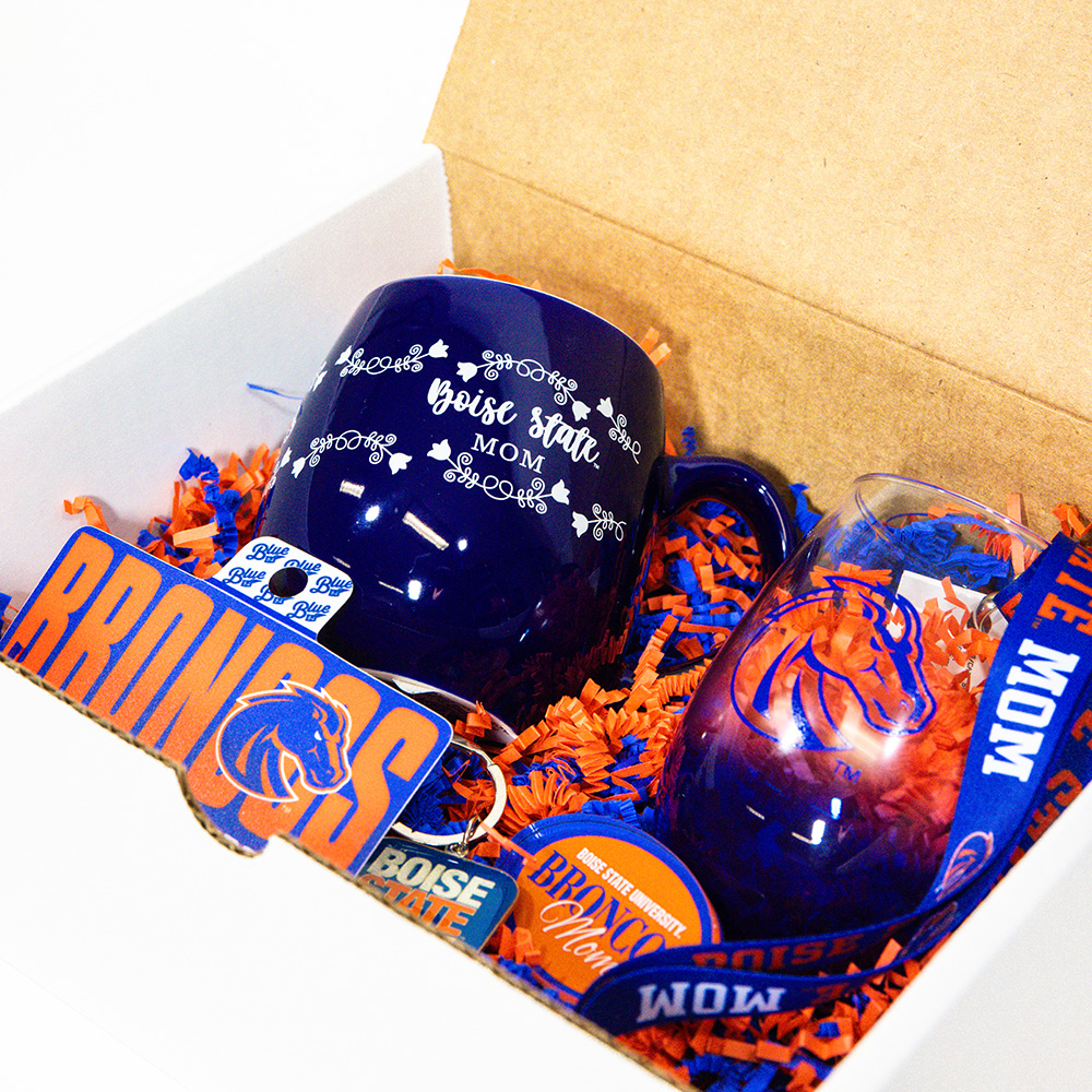 Open Boise State Mother's Day gift box showing the mug, stemless glass, decals, magnet, keychain, and lanyard inside.