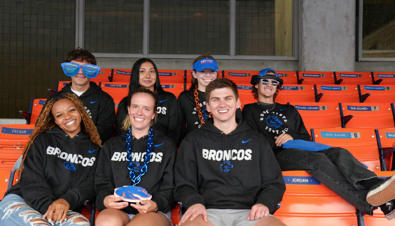 Boise State students wearing Broncos apparel in Albertsons Stadium
