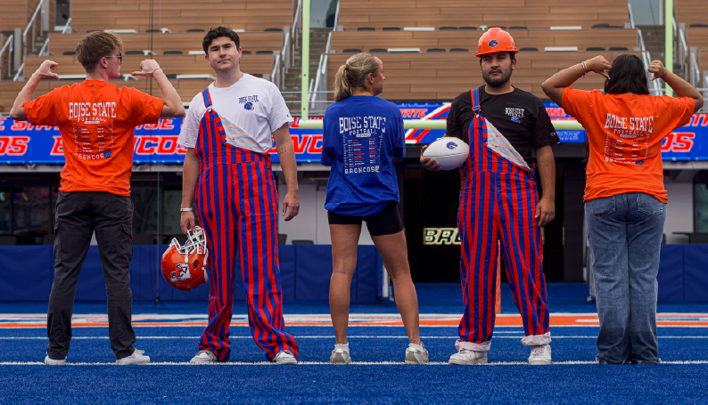 Students model the 2026 Boise State football schedule T-shirt on The Blue