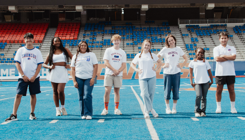 Slideshow image showing a 8 students in white for the Gear Up Monday sale 25% off online for clothing!